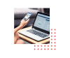 Image of a person holding a mobile phone next to a laptop